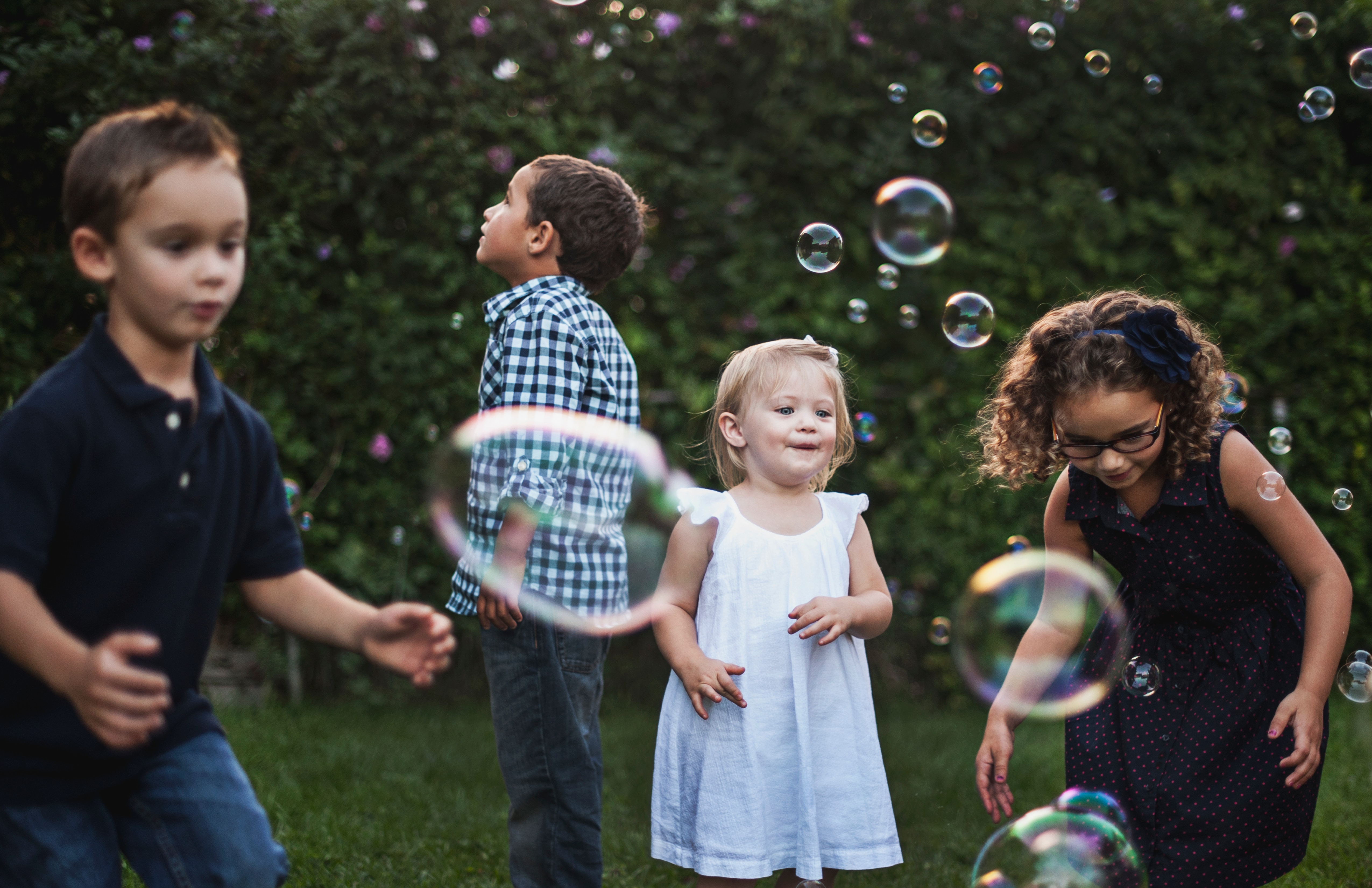 Kids playing with bubbles.